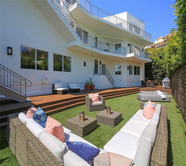 rear view of property with a yard and outdoor lounge area