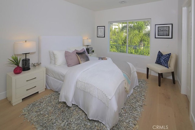 bedroom with light hardwood / wood-style floors