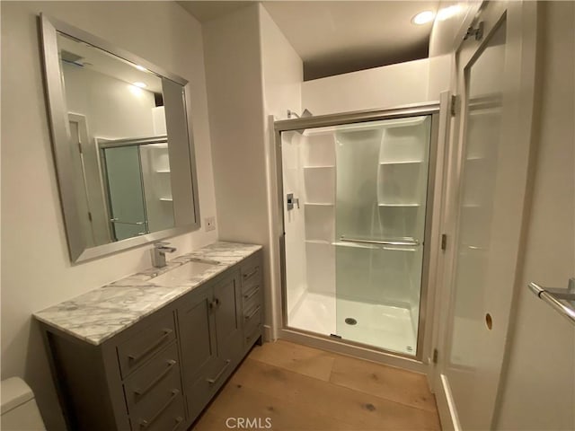 bathroom with vanity, toilet, and walk in shower