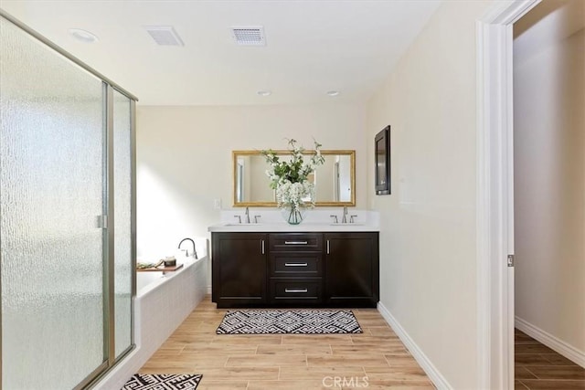 bathroom with vanity and separate shower and tub