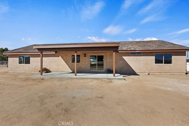 rear view of property featuring a patio