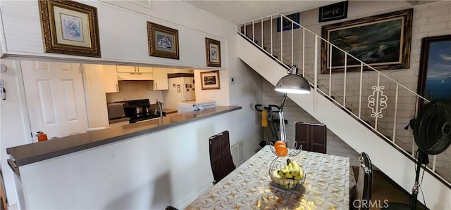 dining area with a textured ceiling