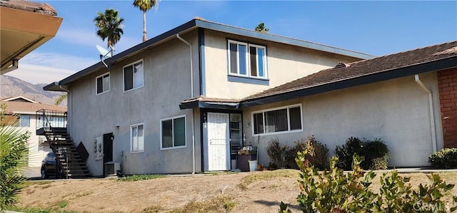 rear view of property with cooling unit