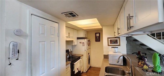 kitchen featuring white cabinetry, sink, white fridge, electric range, and dark wood-type flooring