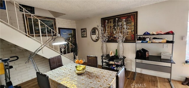 dining room featuring hardwood / wood-style floors and a textured ceiling