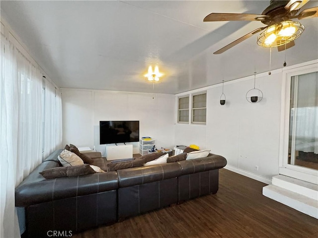 living room with dark hardwood / wood-style floors and ceiling fan