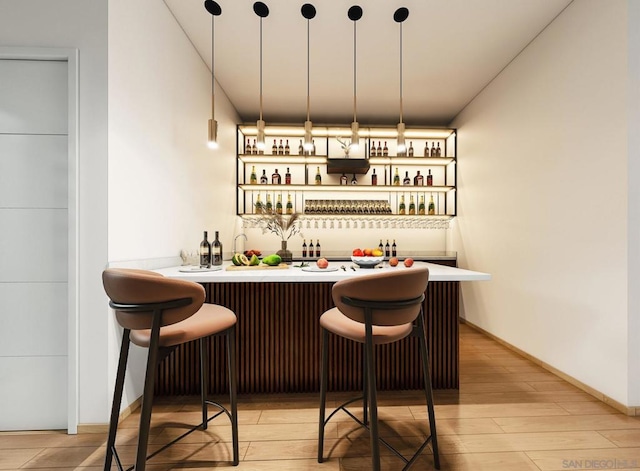 bar featuring hanging light fixtures and light wood-type flooring