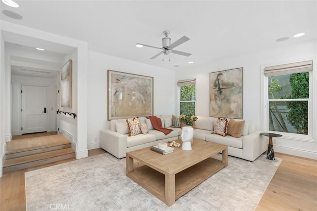 living room with a ceiling fan, recessed lighting, baseboards, and light wood finished floors