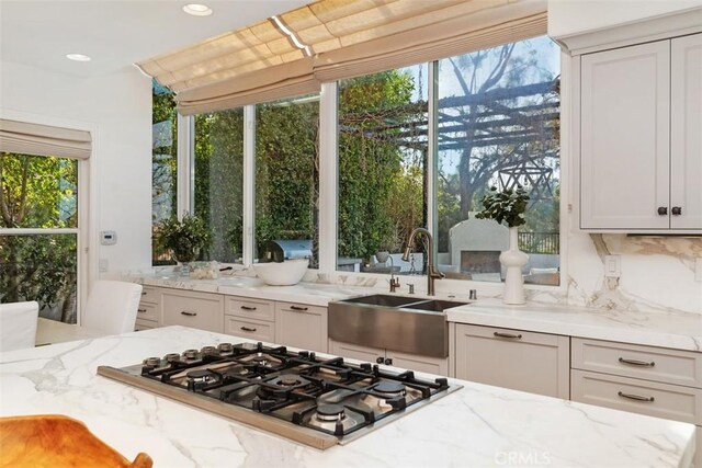 35 Brindisi, Laguna Niguel, CA 92677 - kitchen with stainless steel gas stovetop, light stone countertops, and recessed lighting