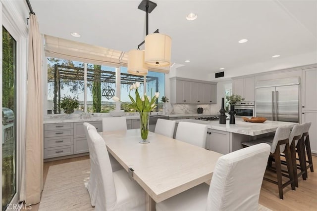 dining space featuring recessed lighting, light wood-style flooring, and visible vents