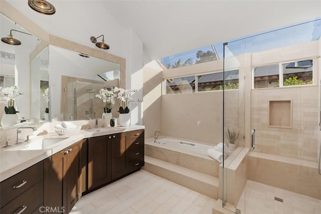 full bathroom featuring a garden tub, double vanity, a stall shower, and a sink