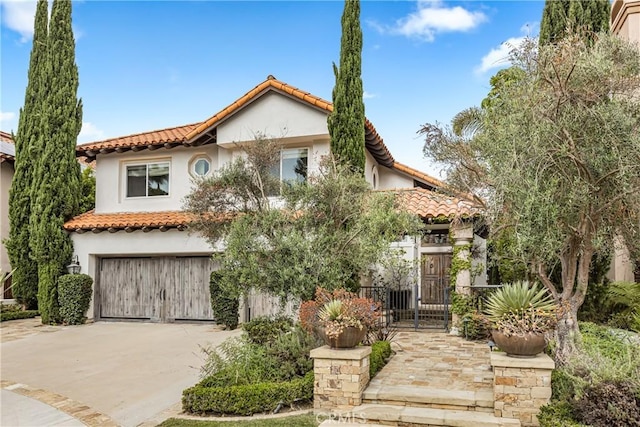 35 Brindisi, Laguna Niguel, CA 92677 - mediterranean / spanish home featuring a tile roof, a garage, stucco siding, concrete driveway, and a gate
