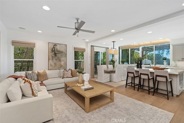 living room featuring recessed lighting, a ceiling fan, and light wood-style floors