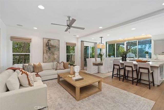 living area featuring recessed lighting, a ceiling fan, and light wood-style floors