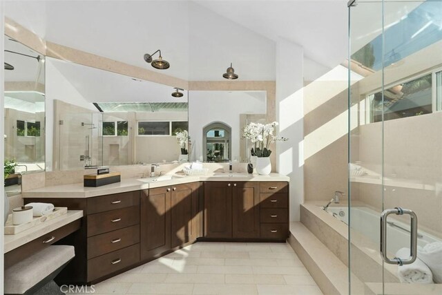 35 Brindisi, Laguna Niguel, CA 92677 - full bathroom with vanity, a stall shower, a bath, tile patterned flooring, and high vaulted ceiling