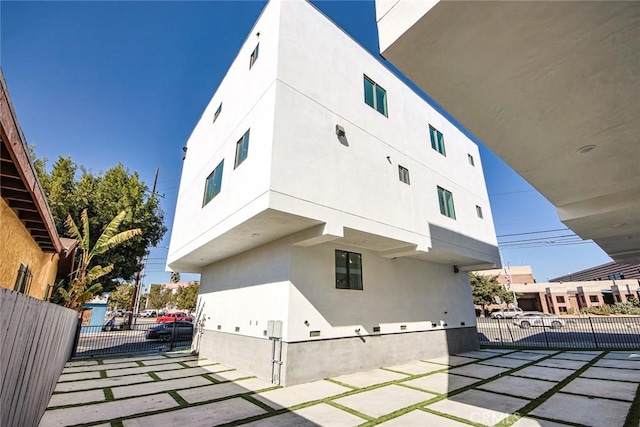 view of property exterior with a patio area