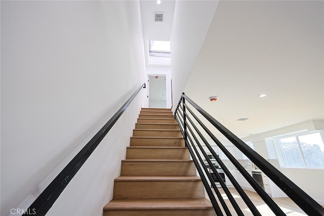 staircase featuring a skylight