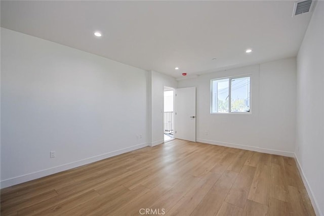 spare room featuring light hardwood / wood-style floors