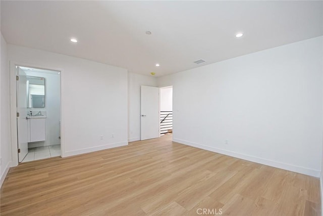 unfurnished room with light hardwood / wood-style floors