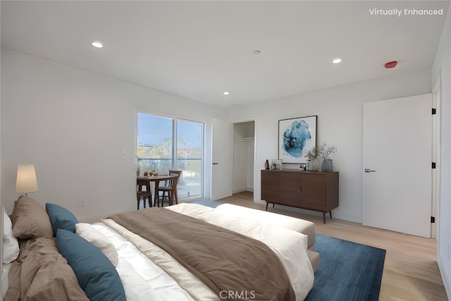 bedroom featuring light hardwood / wood-style flooring and access to outside