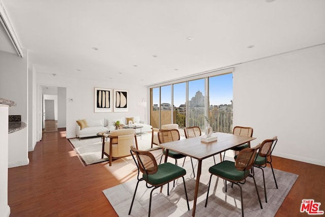 dining room featuring hardwood / wood-style flooring and expansive windows