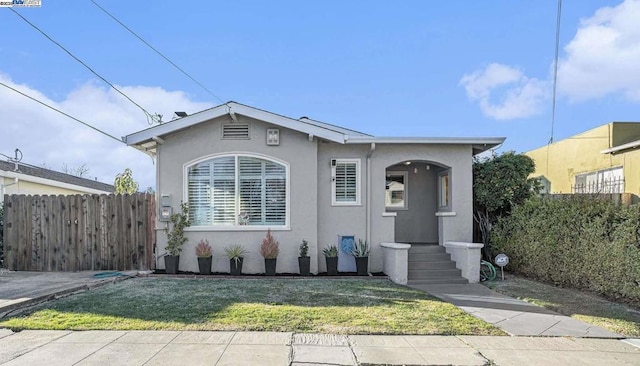 bungalow-style home with a front yard