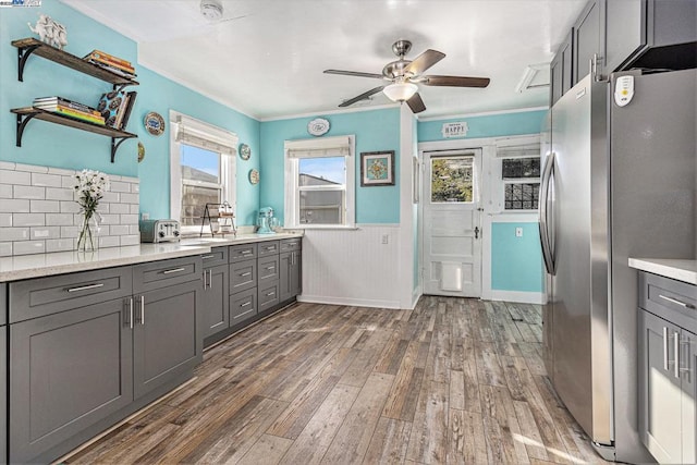 kitchen with dark hardwood / wood-style floors, plenty of natural light, stainless steel fridge, and gray cabinetry