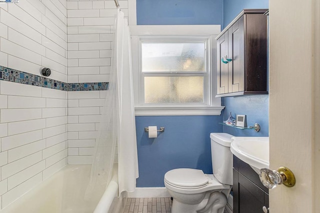 bathroom with shower / bath combo, tile patterned floors, and toilet