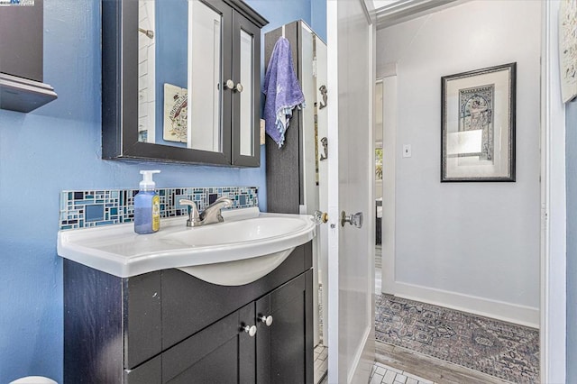 bathroom with tasteful backsplash and vanity