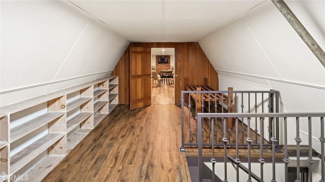 bonus room featuring vaulted ceiling and wood-type flooring