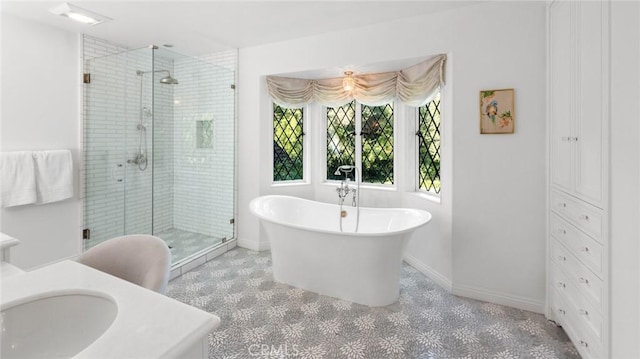 bathroom featuring vanity and separate shower and tub