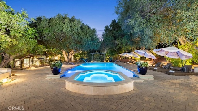 view of swimming pool featuring an in ground hot tub, pool water feature, and a patio