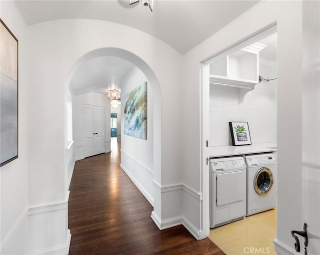 corridor featuring independent washer and dryer and hardwood / wood-style floors