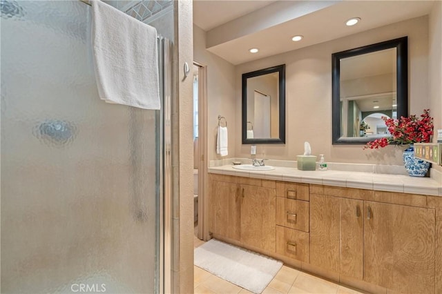 bathroom with vanity, tile patterned floors, and a shower with shower door