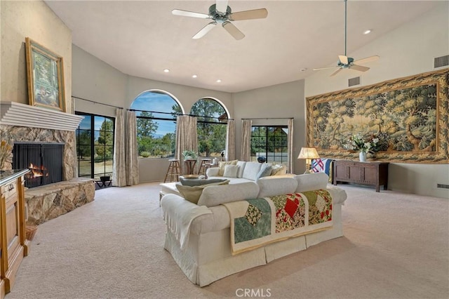 carpeted bedroom featuring ceiling fan, high vaulted ceiling, and a fireplace