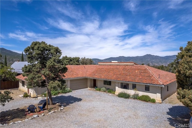 view of front of house with a mountain view and a garage