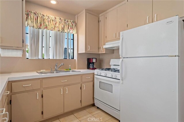 kitchen featuring sink, white appliances, cream cabinetry, and light tile patterned flooring