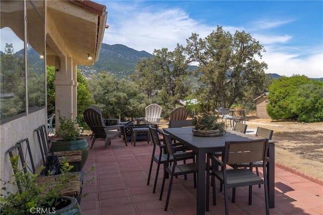 view of patio featuring a mountain view and a fire pit