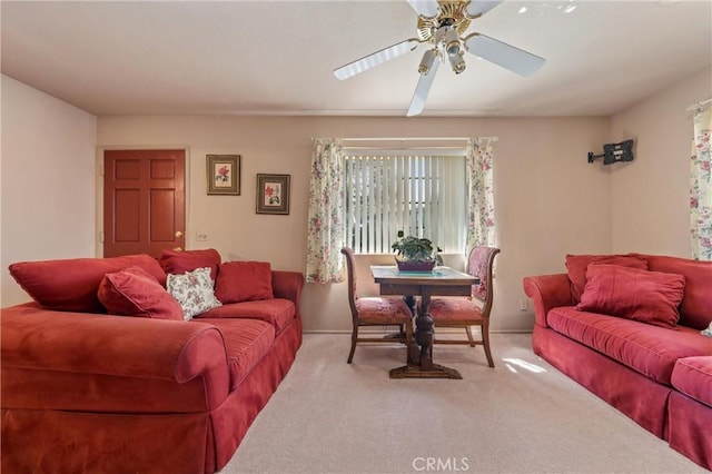 carpeted living room featuring ceiling fan