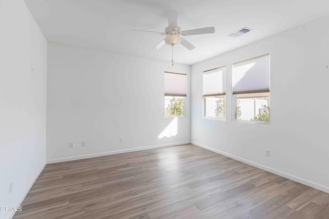 empty room with wood-type flooring and ceiling fan