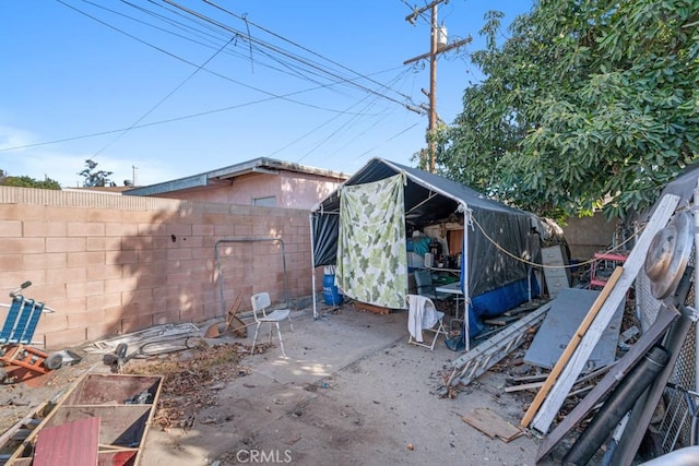 view of outdoor structure with a fenced backyard and an outbuilding