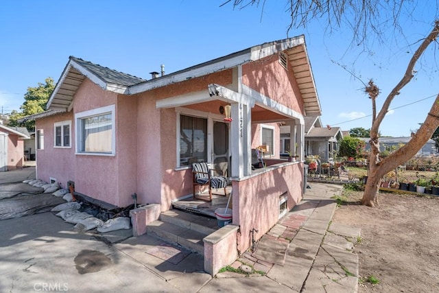 view of front facade featuring a patio area and stucco siding