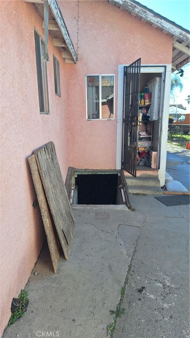 entrance to property featuring stucco siding