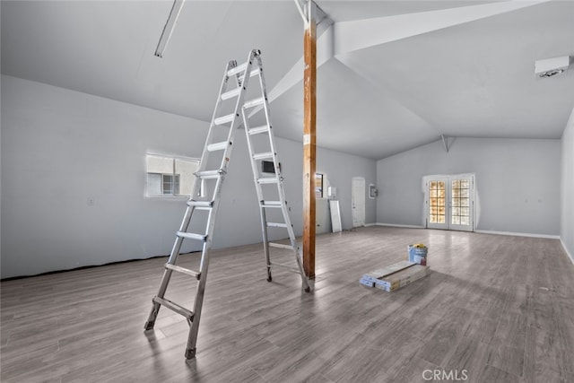 unfurnished living room featuring lofted ceiling and light hardwood / wood-style flooring