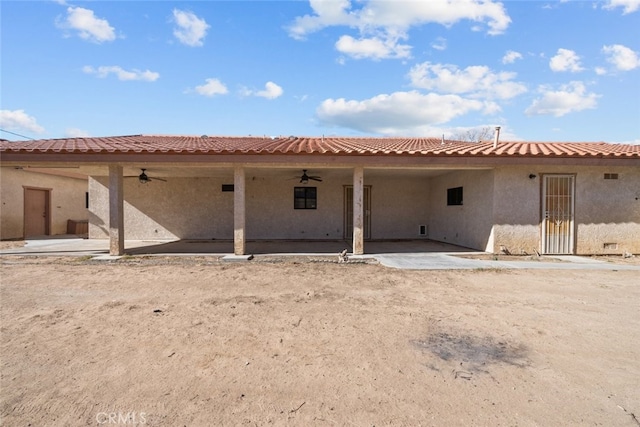 rear view of property with a patio and ceiling fan