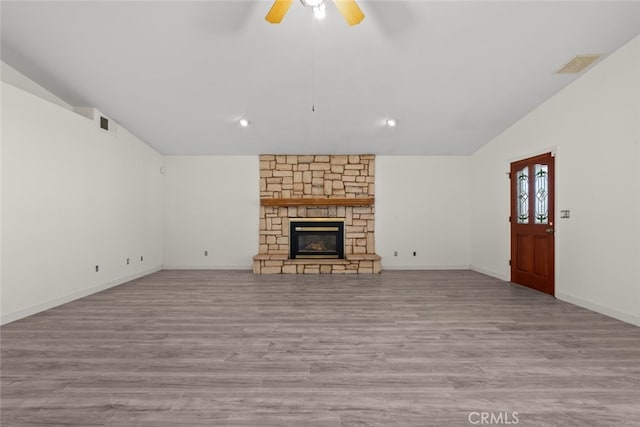 unfurnished living room featuring ceiling fan, a fireplace, and light hardwood / wood-style floors