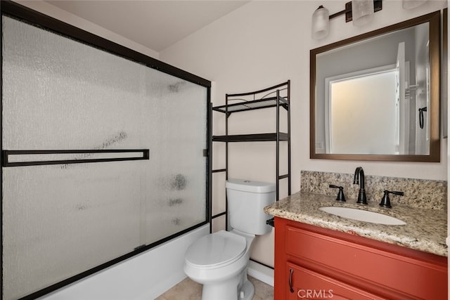 full bathroom featuring toilet, vanity, and bath / shower combo with glass door