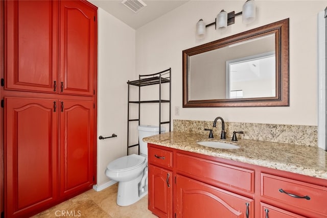 bathroom featuring tile patterned flooring, vanity, and toilet