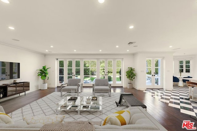 living room featuring crown molding, light hardwood / wood-style floors, and french doors