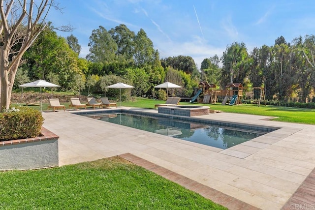 view of pool with a patio area, a pool with connected hot tub, a playground, and a lawn